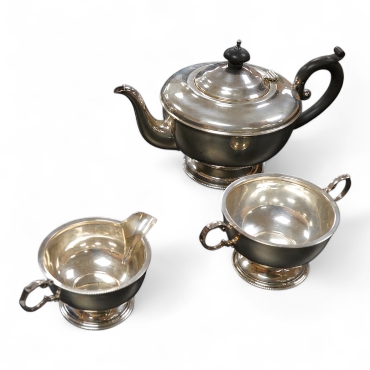 A George V silver three piece tea set teapot handle to spout 24cm., weight approx. 19.28ozt